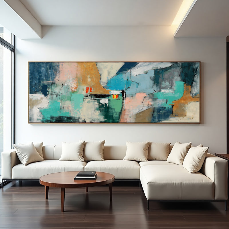 Fading Terrains teal abstract painting displayed above a white sectional sofa