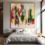 Bloom in Motion square abstract painting with vertical green, red, black and ochre marks above a modern bed