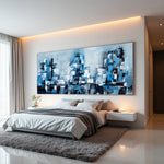 Blue Metropolis blue abstract cityscape painting with layered architectural forms above a modern bed