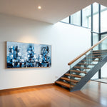Blue Metropolis blue abstract cityscape artwork displayed beside a modern staircase